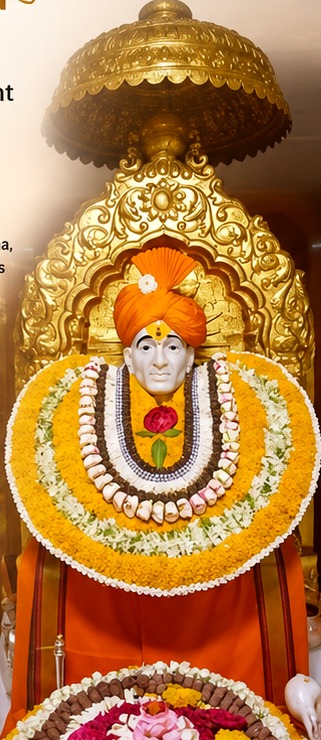 Shri Gajanan Maharaj adorned with garlands inside the sanctum